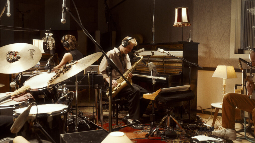 Alban recording on saxophone with his band in the live room of Studio A